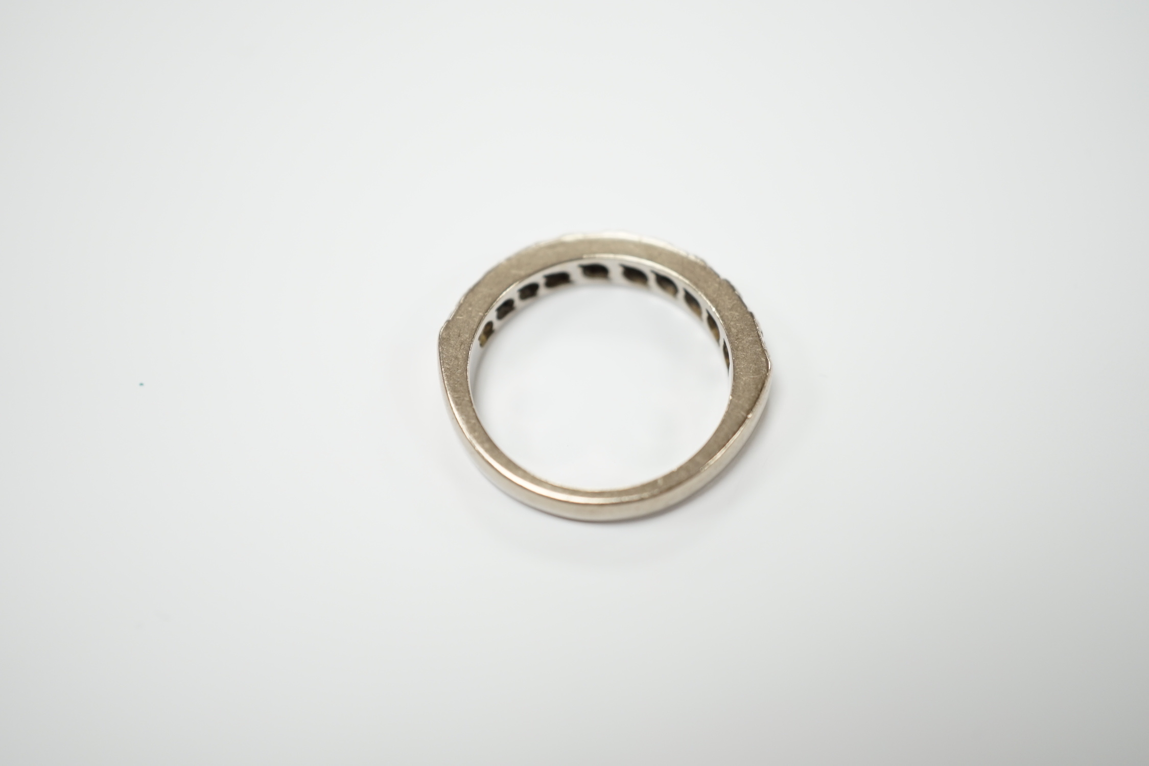 A modern 18ct white gold and nine stone diamond set half eternity ring, size M, gross weight 5.3 grams.